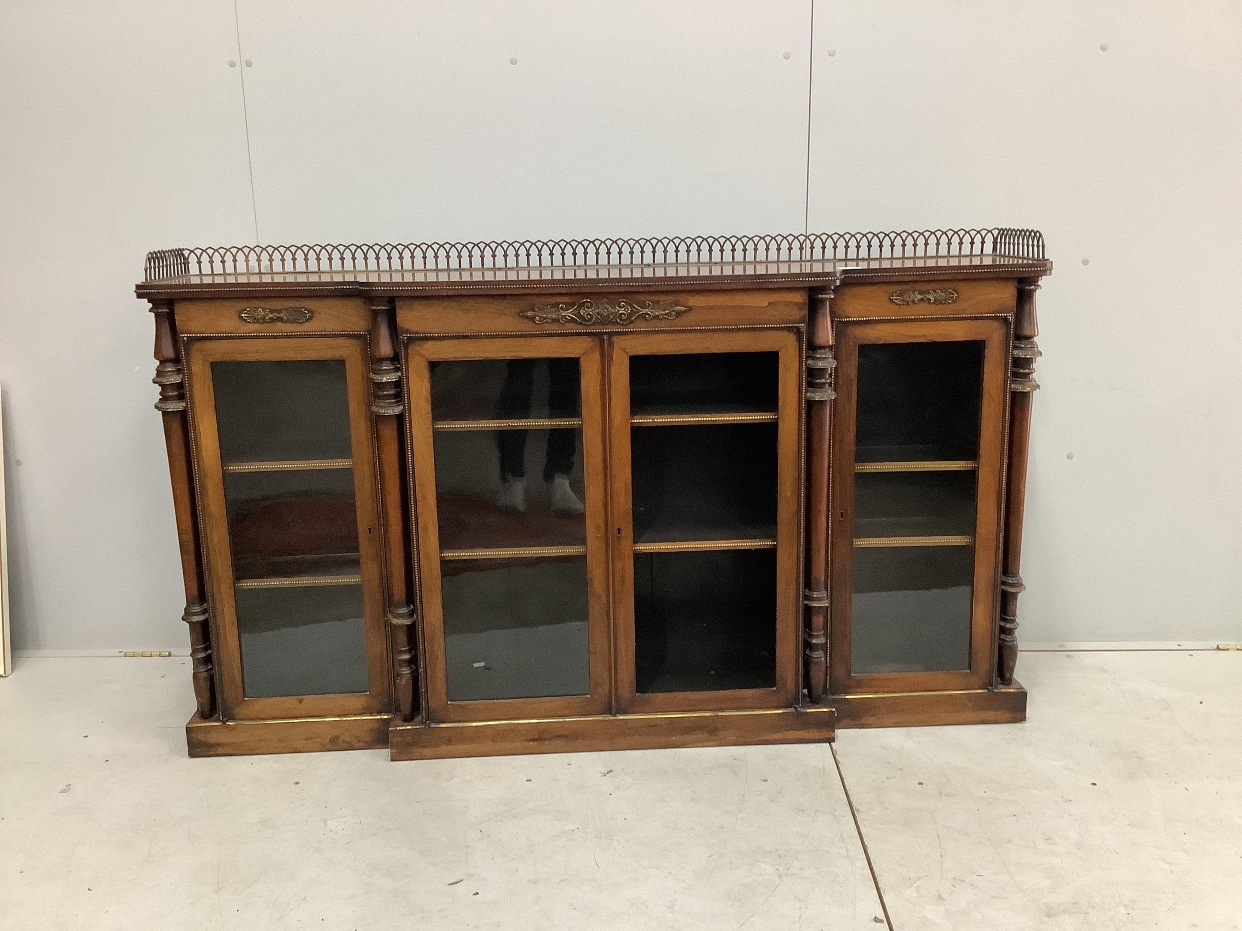 An early Victorian rosewood breakfront dwarf bookcase, width 168cm, height 97cm. Condition - one glazed panel missing, otherwise fair to good